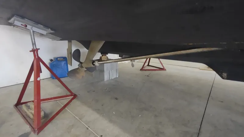  Yacht Photos Pics Underneath view of a 2000 Tiara Yachts 3500 Open on red stands in a garage.