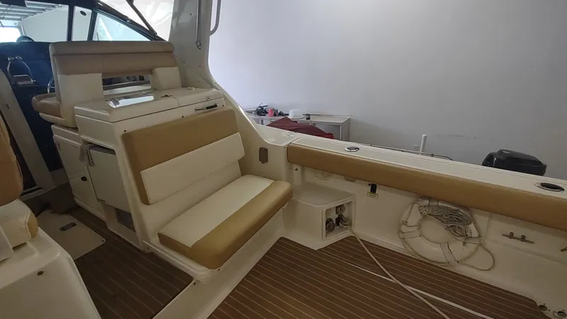  Yacht Photos Pics Interior of 2000 Tiara Yachts 3500 Open, featuring beige seating and wooden flooring.