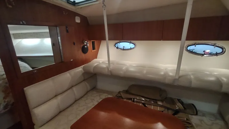  Yacht Photos Pics Interior of 2000 Tiara Yachts 3500 Open, featuring cozy seating and porthole windows.