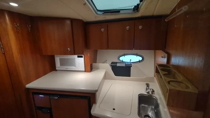  Yacht Photos Pics 2000 Tiara Yachts 3500 Open interior kitchen with wood cabinets and modern amenities.