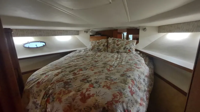  Yacht Photos Pics Cozy cabin interior of 2000 Tiara Yachts 3500 Open with floral bedding.