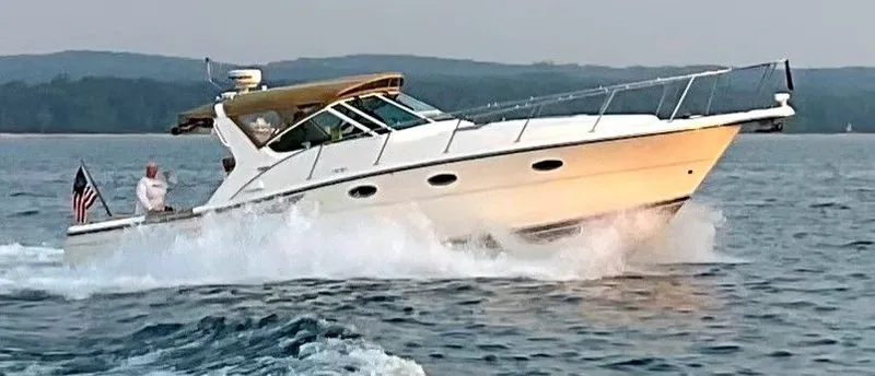  Yacht Photos Pics 2000 Tiara Yachts 3500 Open cruising on water with American flag.