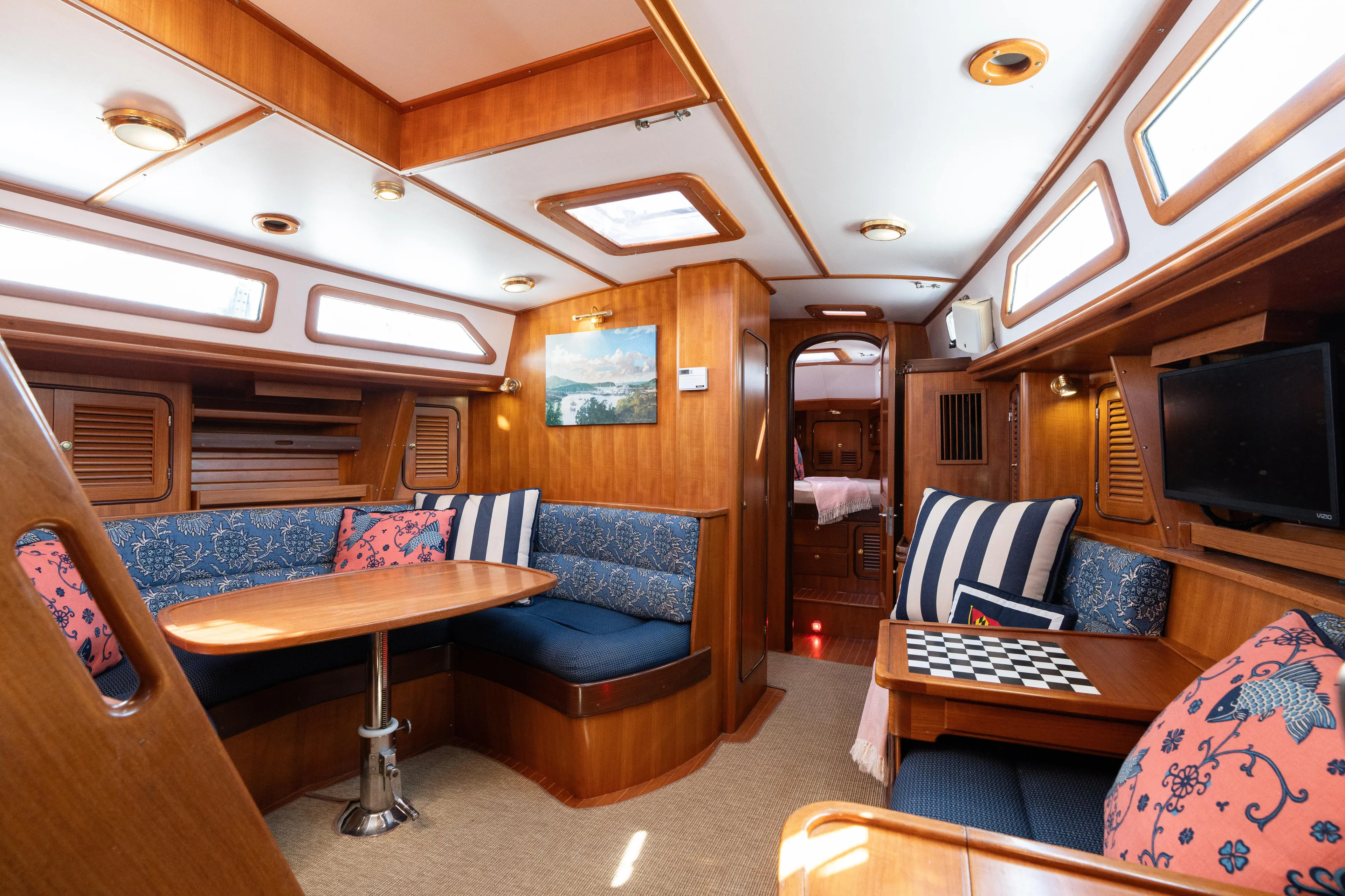 Altair Yacht Photos Pics Luxurious interior of 2002 Passport 470 Center Cockpit Ketch with elegant wood finish and cozy seating.