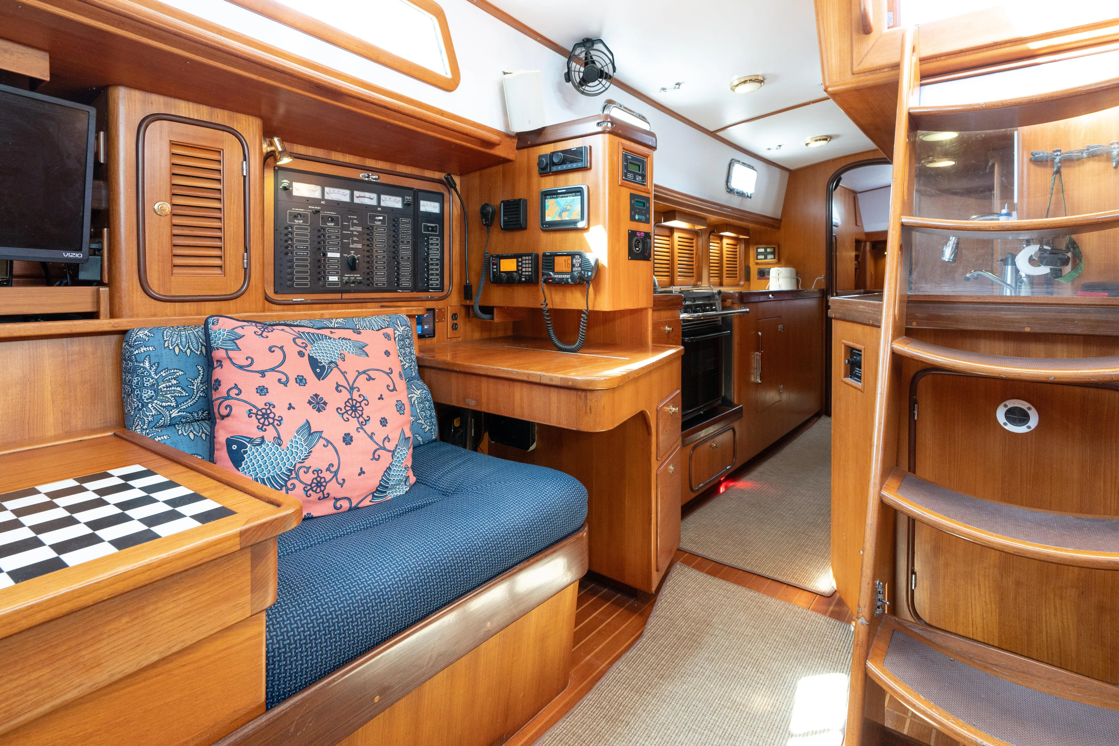 Altair Yacht Photos Pics Interior of 2002 Passport 470 Center Cockpit Ketch with wood finish and navigation equipment.