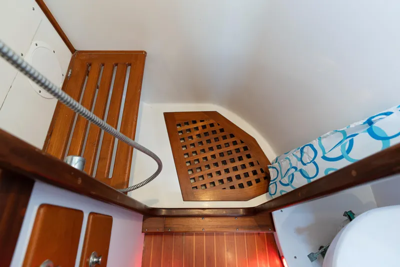 Altair Yacht Photos Pics Interior of 2002 Passport 470 Center Cockpit Ketch with wooden accents and patterned cushion.