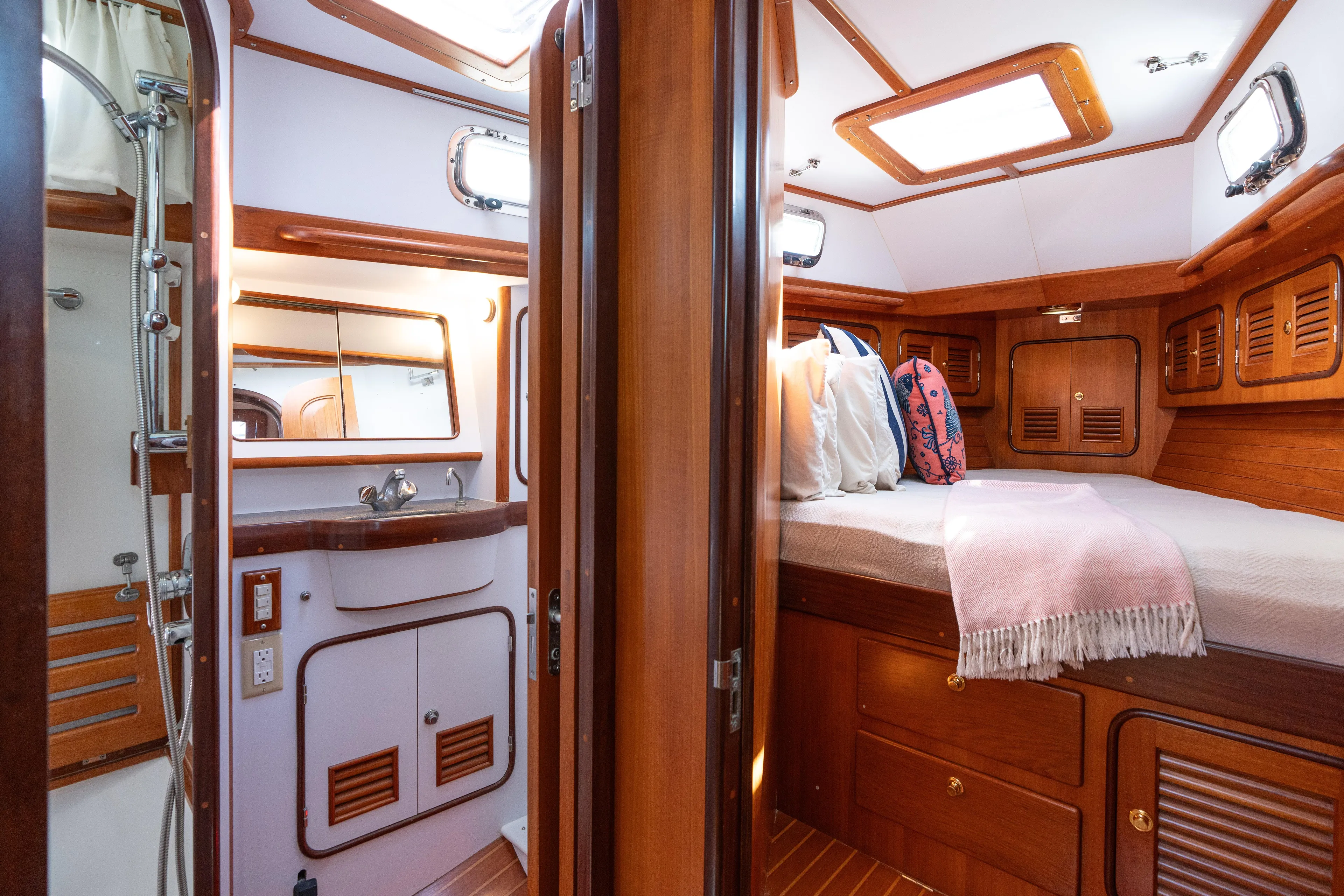 Altair Yacht Photos Pics Luxurious interior of 2002 Passport 470 Center Cockpit Ketch with cozy cabin and bathroom.