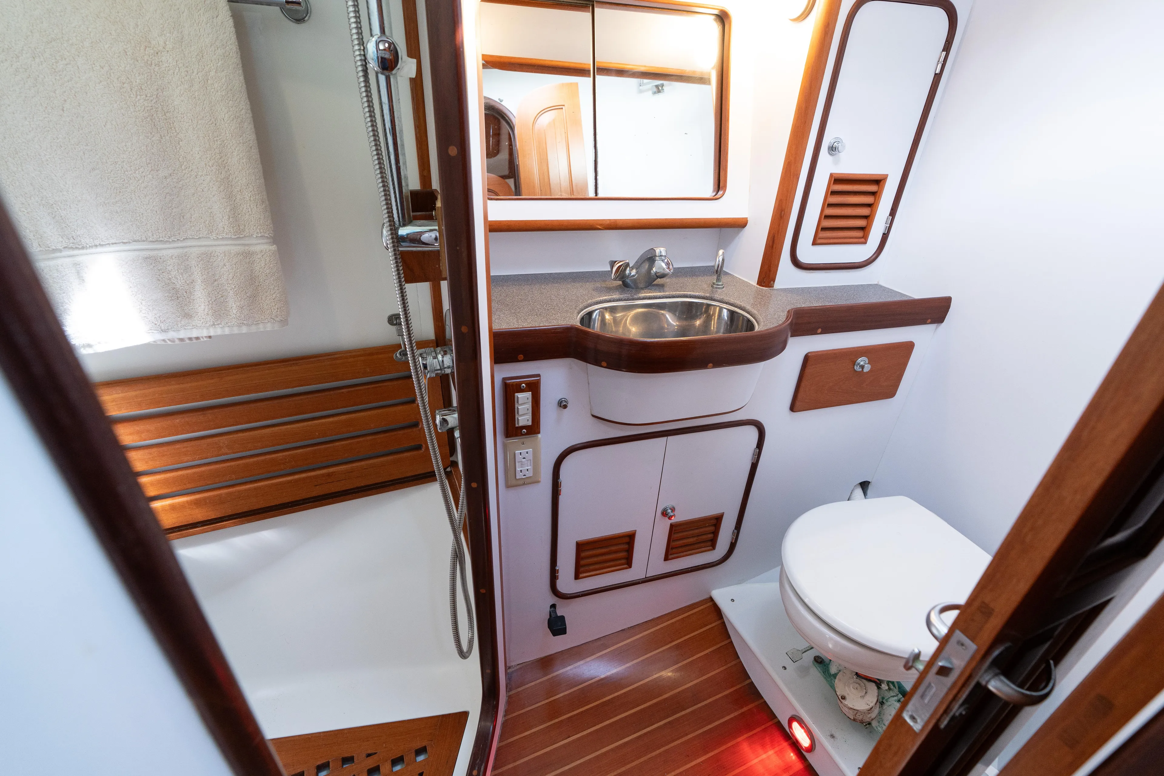 Altair Yacht Photos Pics Bathroom interior of 2002 Passport 470 Center Cockpit Ketch yacht, featuring sink and toilet.