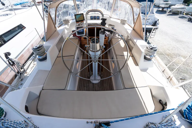 Altair Yacht Photos Pics Cockpit of 2002 Passport 470 Center Cockpit Ketch with steering wheel and navigation equipment.
