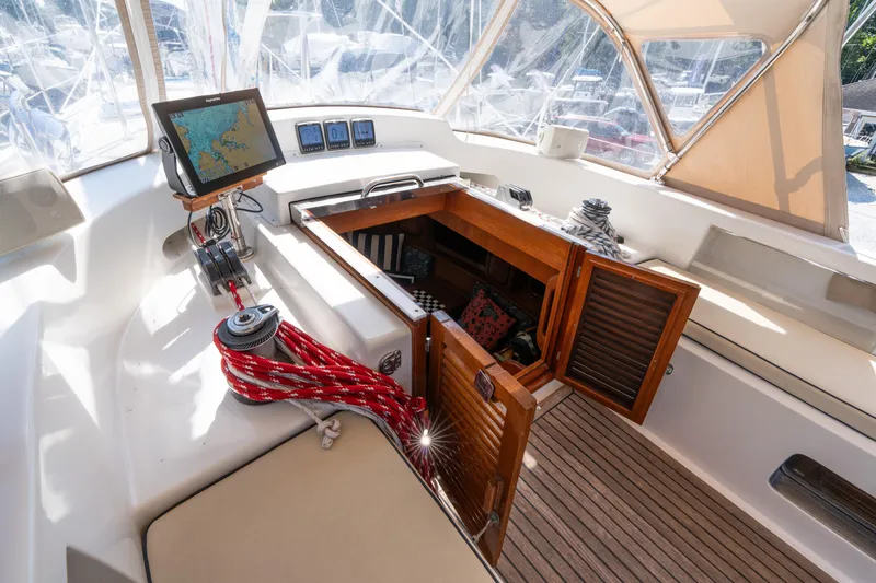 Altair Yacht Photos Pics Cockpit of 2002 Passport 470 Center Cockpit Ketch with navigation equipment and open hatch.