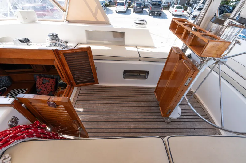 Altair Yacht Photos Pics Interior view of 2002 Passport 470 Center Cockpit Ketch with open wooden cabinets and seating.