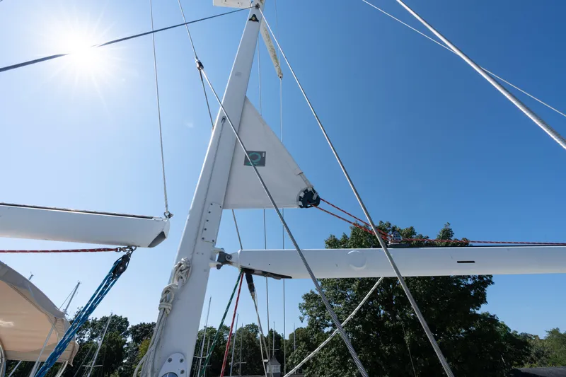 Altair Yacht Photos Pics Sailboat rigging on a 2002 Passport 470 Center Cockpit Ketch under a clear blue sky.
