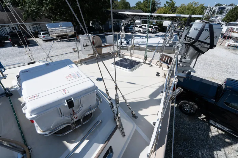 Altair Yacht Photos Pics Deck view of 2002 Passport 470 Center Cockpit Ketch with equipment and outboard motor.