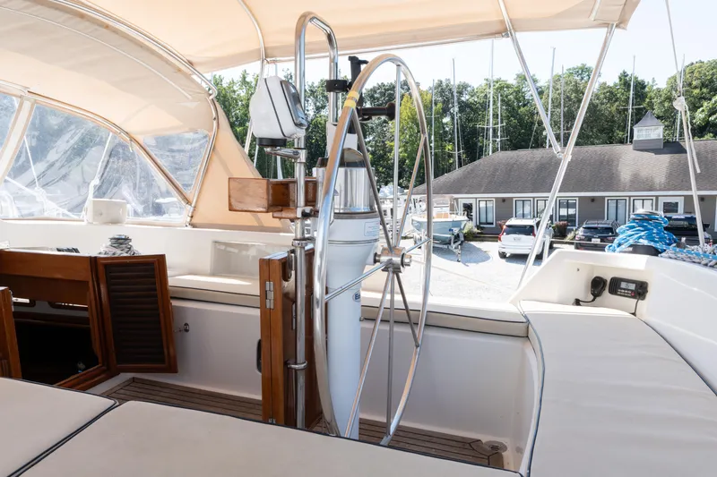 Altair Yacht Photos Pics Cockpit of 2002 Passport 470 Center Cockpit Ketch with steering wheel and seating area.