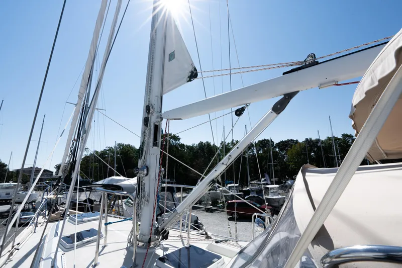 Altair Yacht Photos Pics Sailing yacht Passport 470 Center Cockpit Ketch, 2002, docked under clear blue sky.
