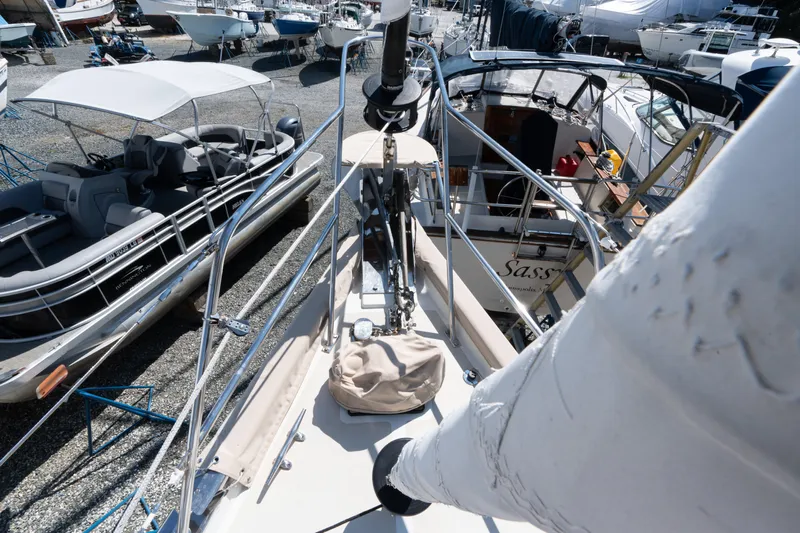 Altair Yacht Photos Pics 2002 Passport 470 Center Cockpit Ketch in a boatyard, surrounded by other vessels.