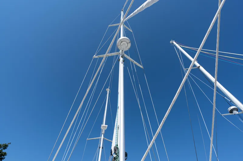 Altair Yacht Photos Pics Masts and rigging of 2002 Passport 470 Center Cockpit Ketch against clear blue sky.