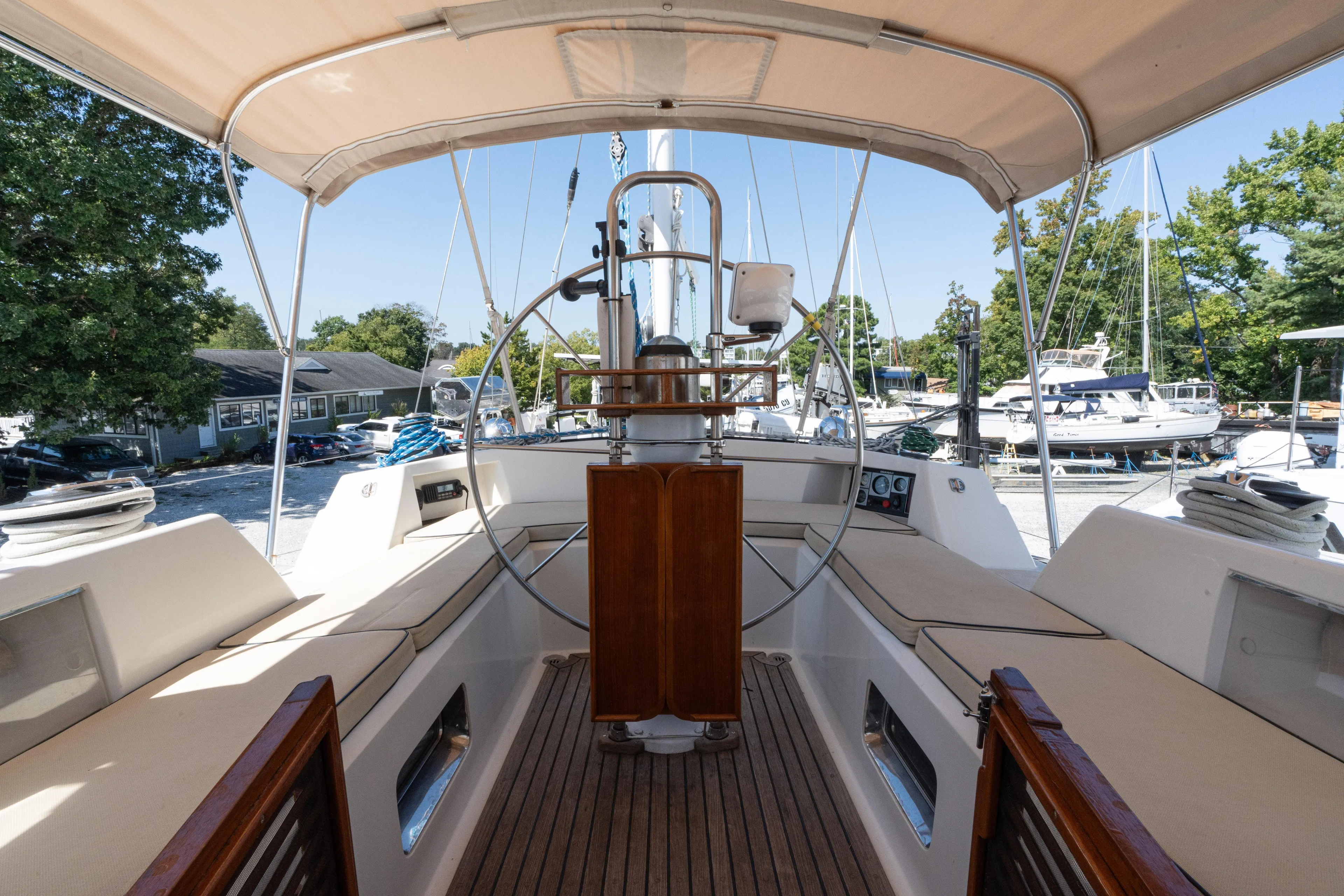 Altair Yacht Photos Pics Cockpit view of 2002 Passport 470 Center Cockpit Ketch sailboat, featuring helm and seating.