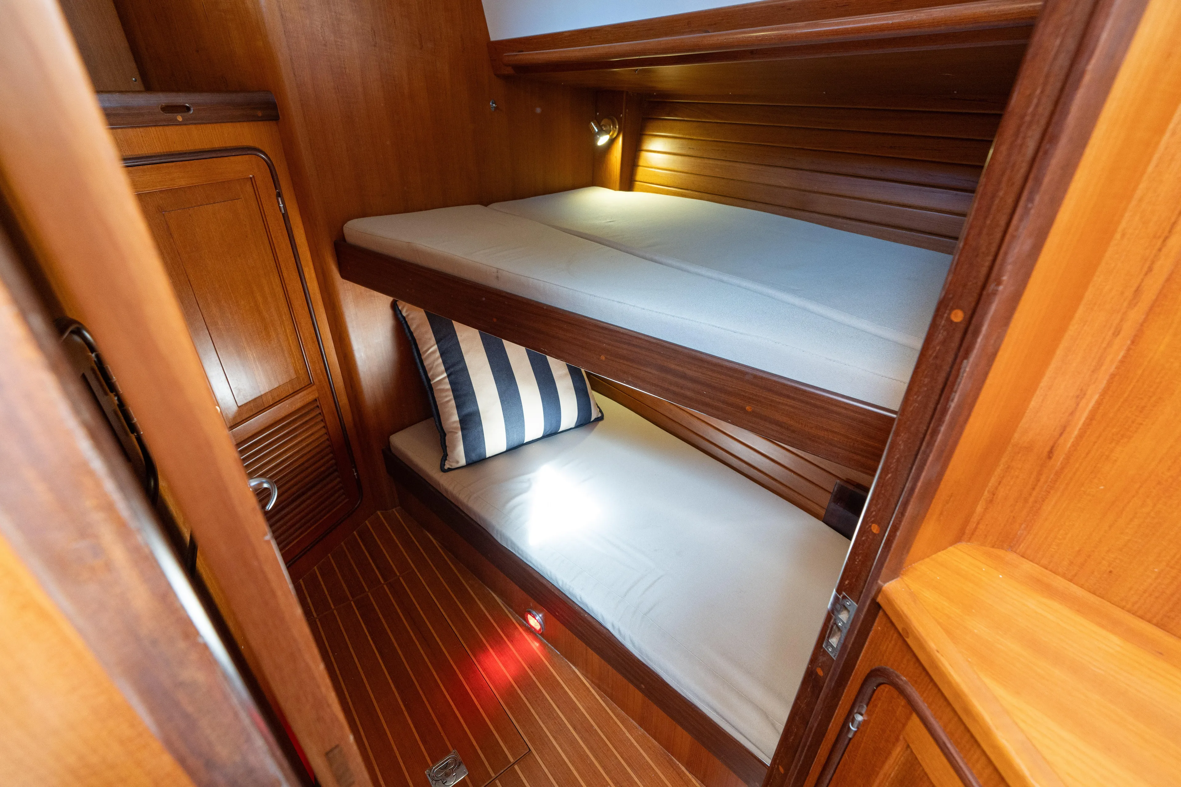 Altair Yacht Photos Pics Cozy cabin with wooden bunk beds in 2002 Passport 470 Center Cockpit Ketch.