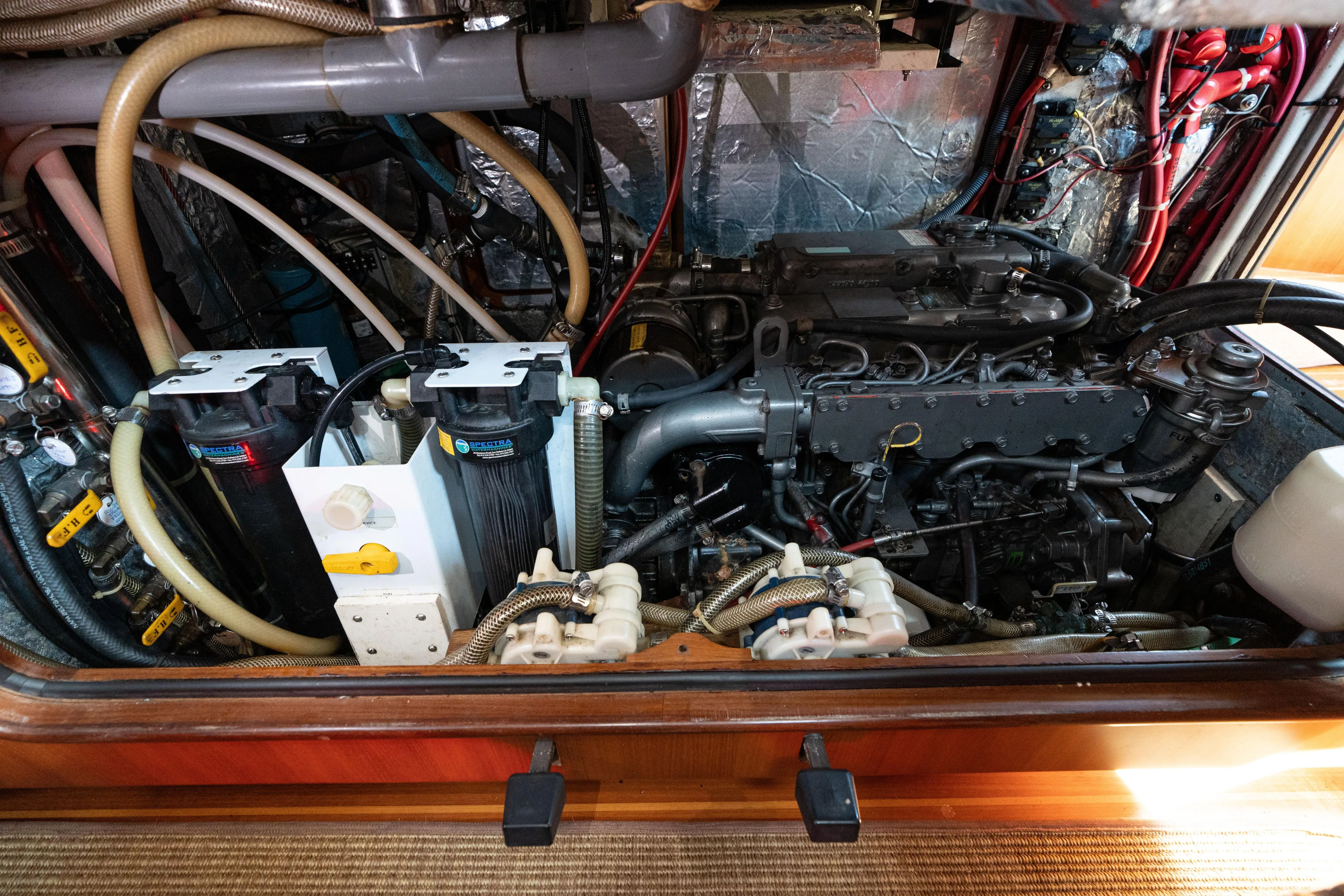 Altair Yacht Photos Pics Engine room of 2002 Passport 470 Center Cockpit Ketch with visible machinery and wiring.