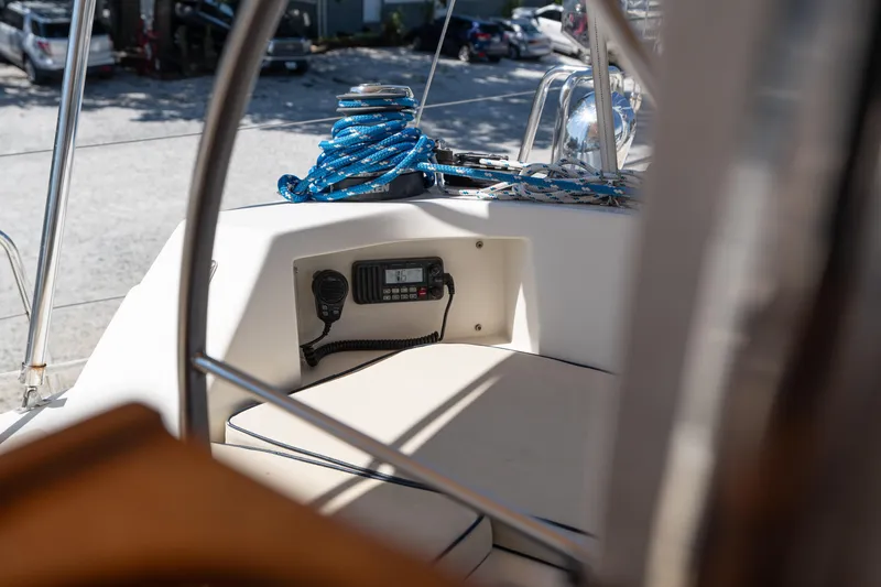 Altair Yacht Photos Pics Cockpit view of 2002 Passport 470 Center Cockpit Ketch with radio and coiled rope.