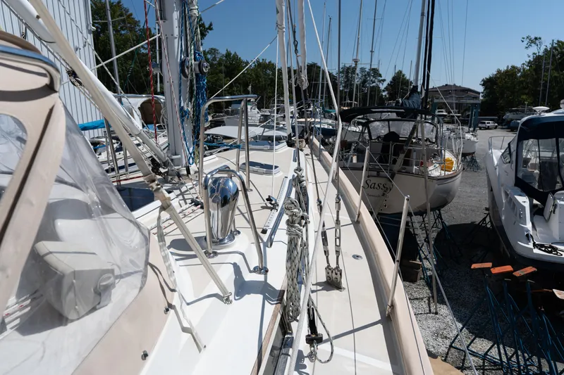 Altair Yacht Photos Pics 2002 Passport 470 Center Cockpit Ketch sailboat docked among other boats in a marina.