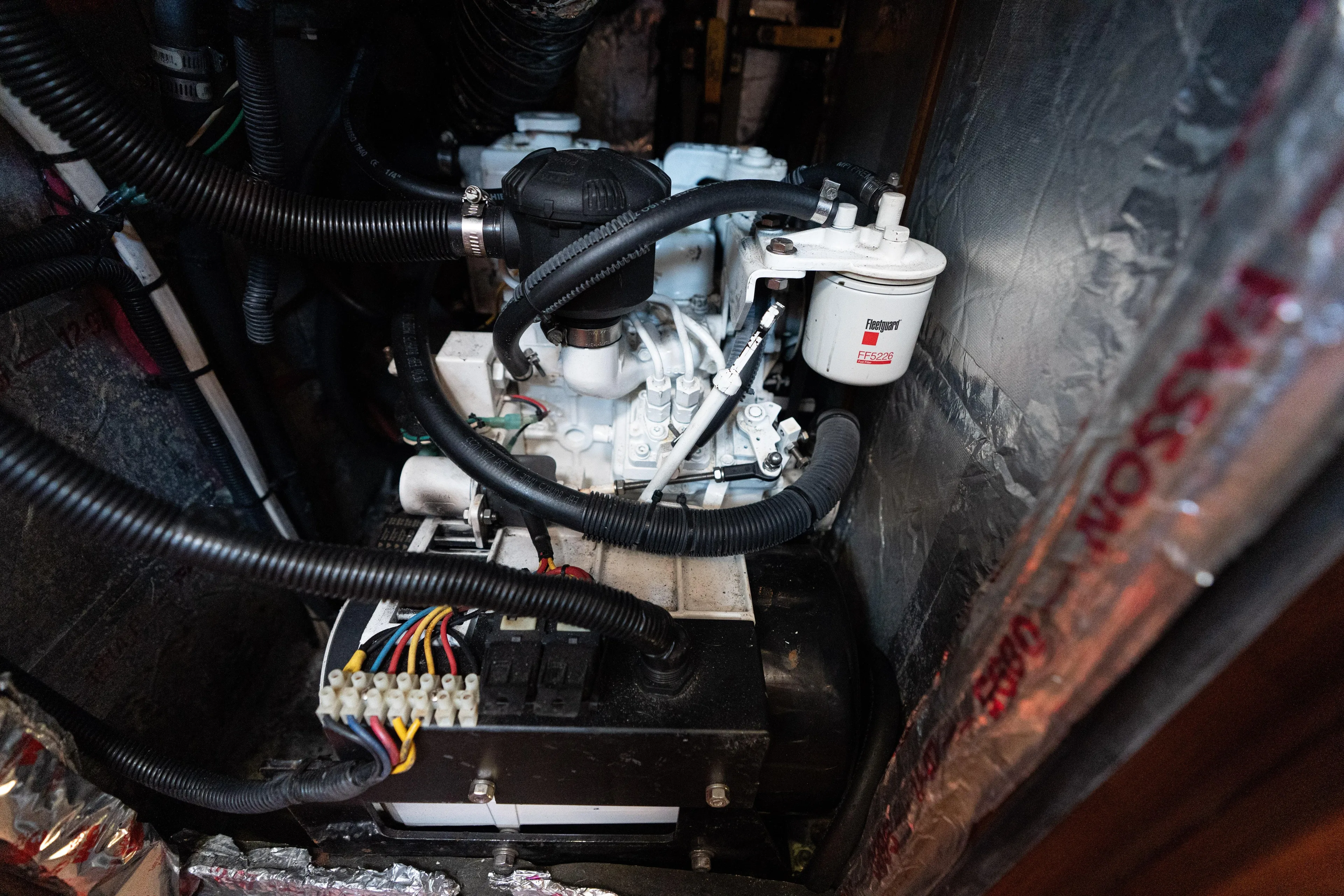 Altair Yacht Photos Pics Engine compartment of 2002 Passport 470 Center Cockpit Ketch with visible wiring and components.