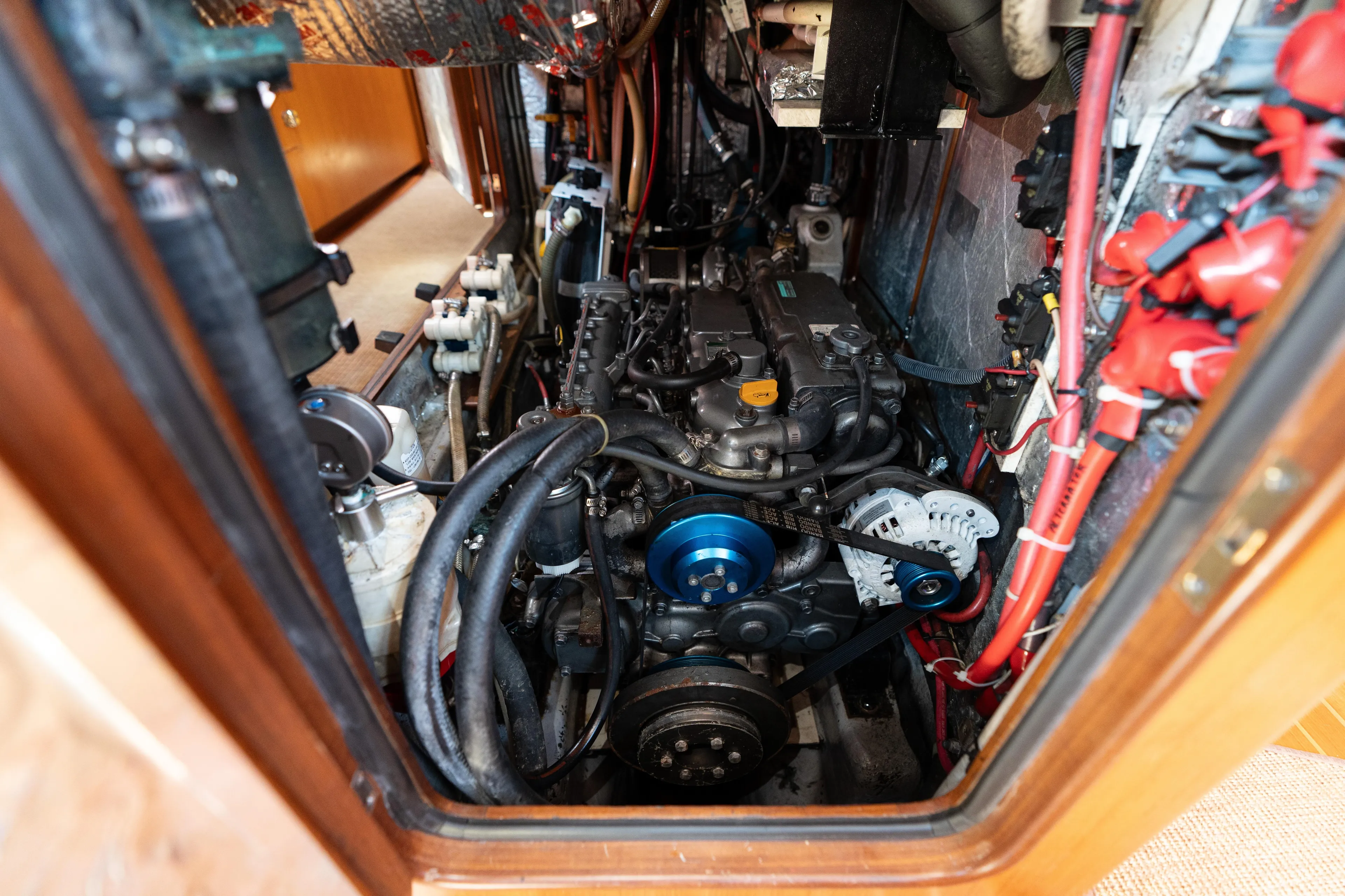 Altair Yacht Photos Pics Engine room of 2002 Passport 470 Center Cockpit Ketch, showcasing mechanical components and wiring.