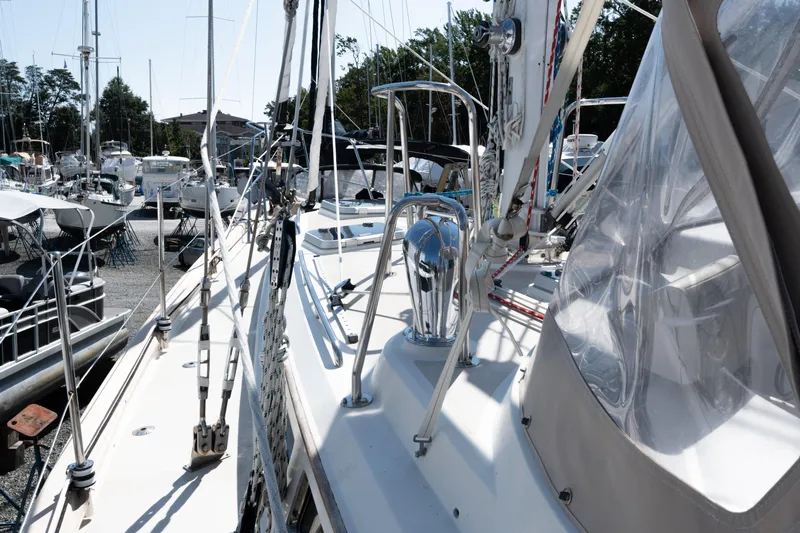 Altair Yacht Photos Pics Sailboat deck view of 2002 Passport 470 Center Cockpit Ketch in marina setting.