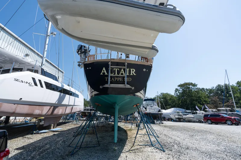 Altair Yacht Photos Pics 2002 Passport 470 Center Cockpit Ketch sailboat on stands in a boatyard.