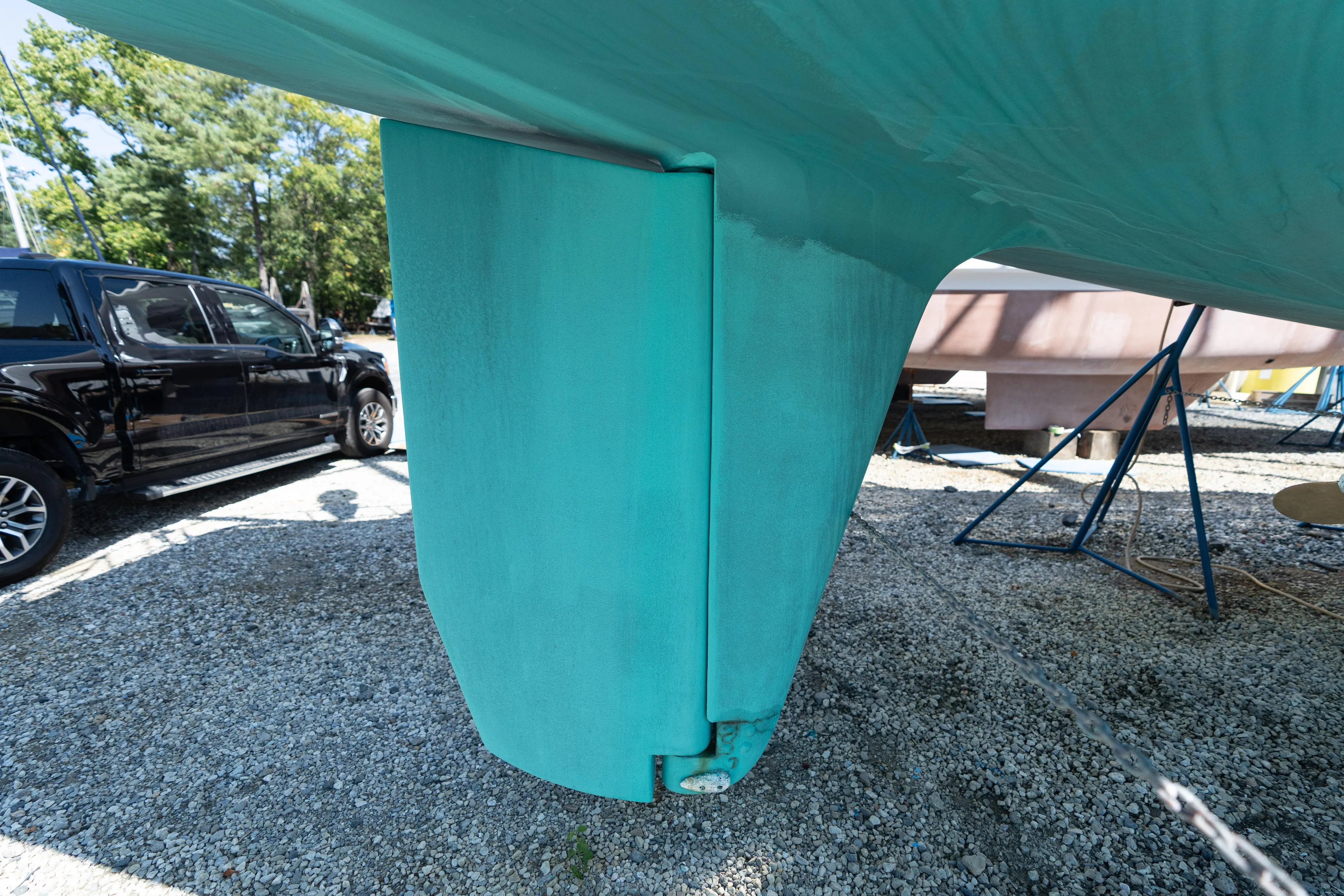 Altair Yacht Photos Pics Close-up of 2002 Passport 470 Center Cockpit Ketch rudder in a boatyard.