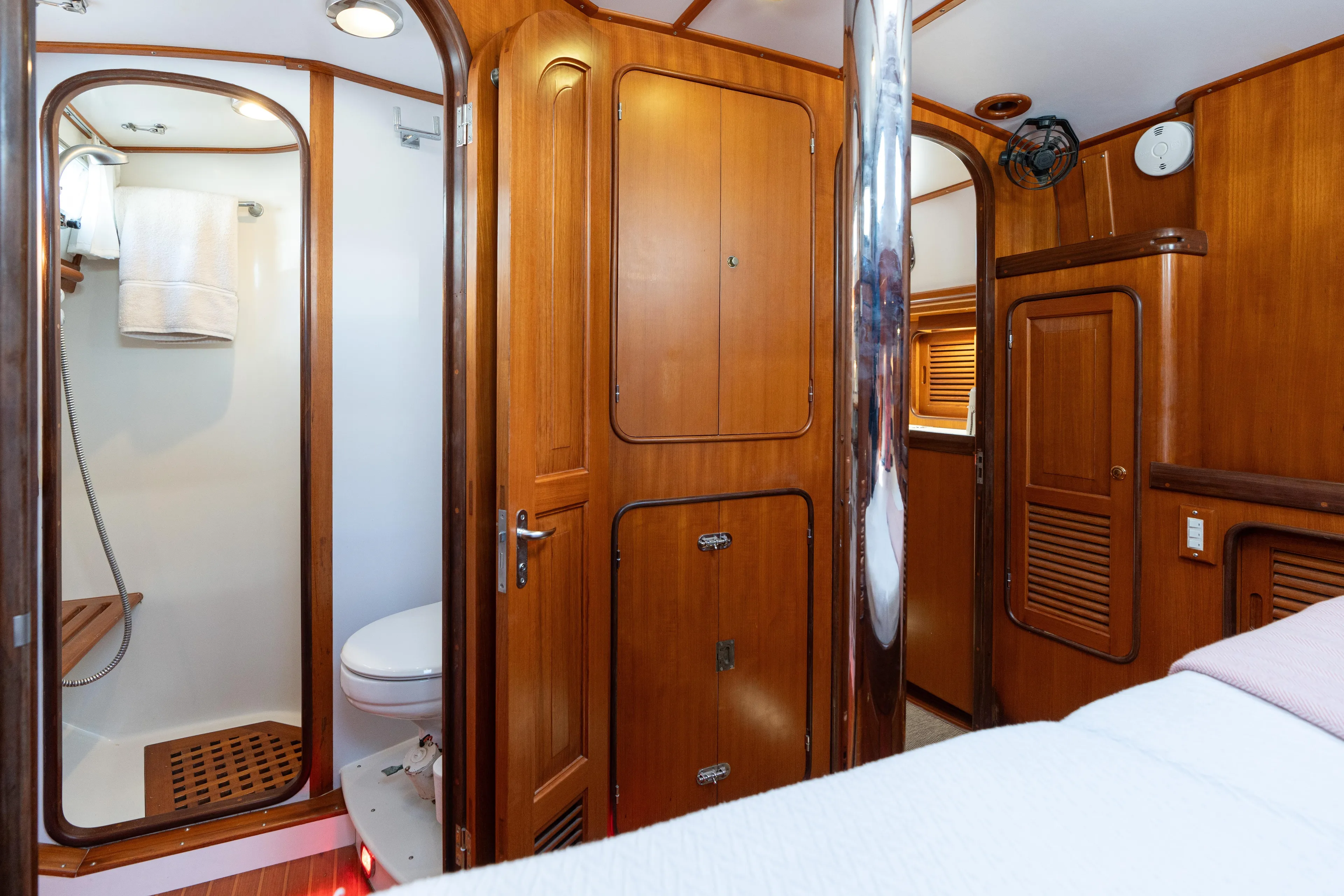 Altair Yacht Photos Pics Luxurious wooden interior of 2002 Passport 470 Center Cockpit Ketch with bathroom and storage.