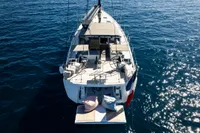 Luxury CNB 66 yacht on open sea, 2021 model, with spacious deck and seating area.