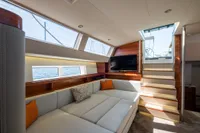 Luxurious interior of 2021 CNB 66 yacht with modern seating and large windows.