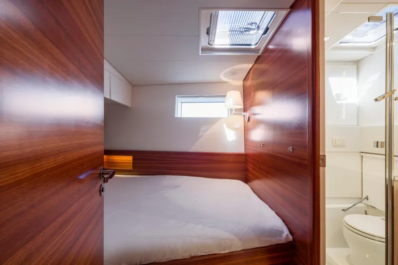 Dream On Yacht Photos Pics Luxurious cabin interior of 2021 CNB 66 yacht with wooden finish and cozy bed.