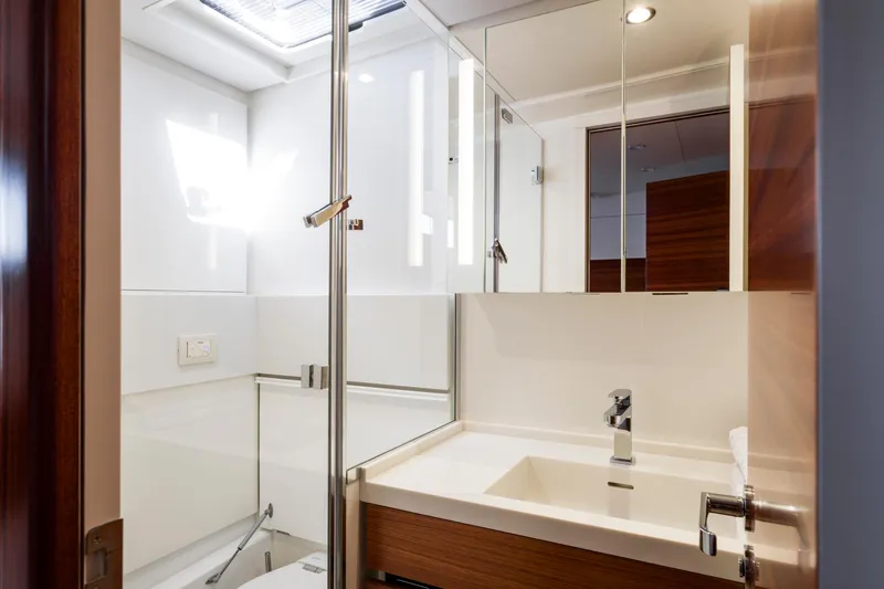 Dream On Yacht Photos Pics Modern bathroom interior on CNB 66 yacht, 2021 model, featuring sleek design and glass shower.