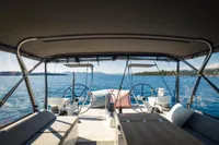 Luxurious CNB 66 yacht interior with dual steering wheels, overlooking serene ocean waters.