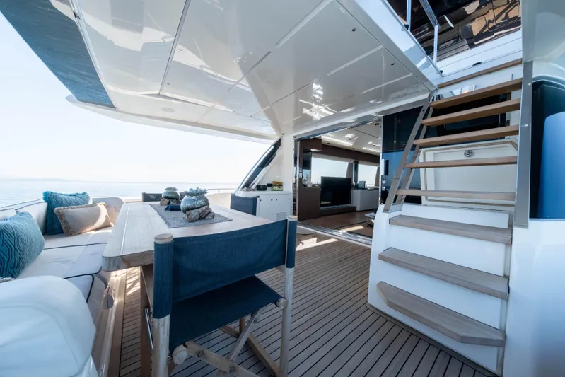 Dogu Yacht Photos Pics Luxurious 2021 Ferretti Yachts 780 interior with elegant seating and wooden flooring.