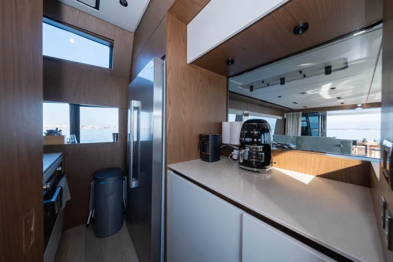 Dogu Yacht Photos Pics Modern kitchen interior on 2021 Ferretti Yachts 780, featuring sleek design and appliances.