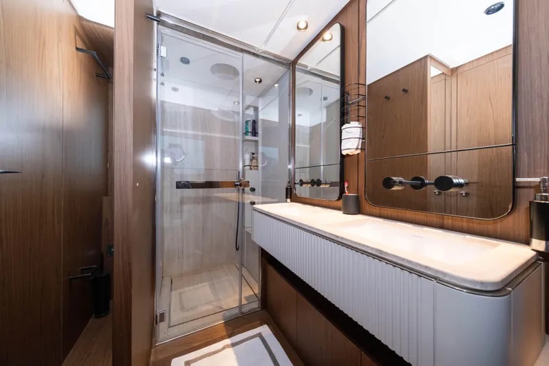 Dogu Yacht Photos Pics Luxurious bathroom in 2021 Ferretti Yachts 780, featuring modern shower and elegant wood finishes.