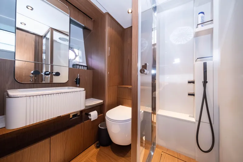 Dogu Yacht Photos Pics Luxurious bathroom in 2021 Ferretti Yachts 780, featuring modern fixtures and elegant wood finishes.