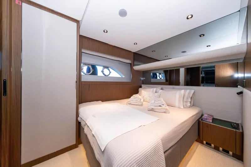 Dogu Yacht Photos Pics Luxurious bedroom interior on 2021 Ferretti Yachts 780, featuring elegant wood finishes and modern design.