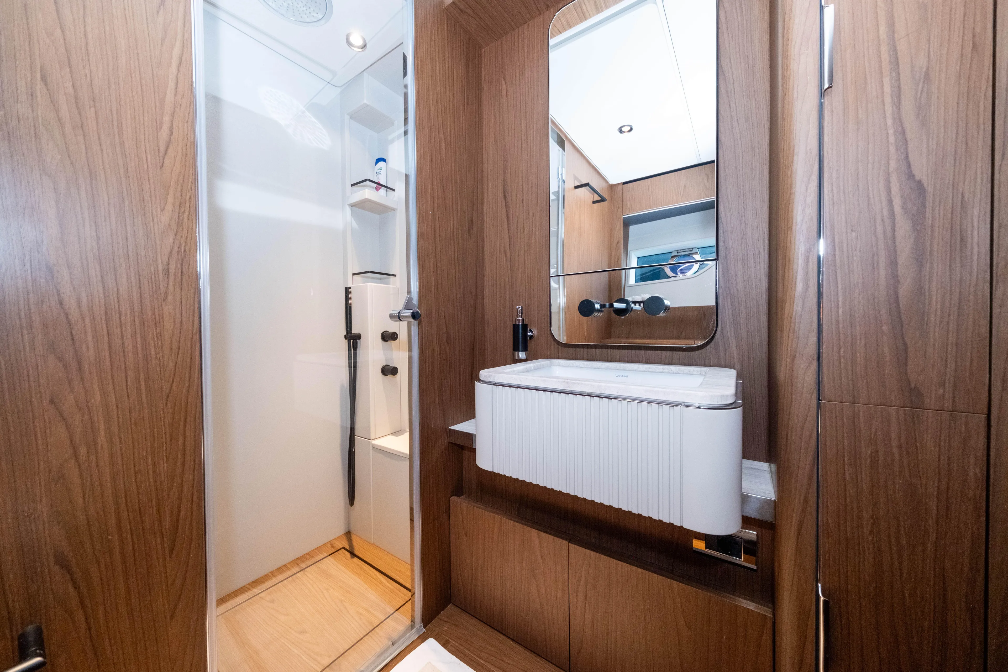 Dogu Yacht Photos Pics Luxurious bathroom interior on 2021 Ferretti Yachts 780, featuring modern wood finishes.