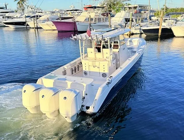  Yacht Photos Pics 2014 Everglades 355 Center Console boat with triple engines in a marina setting.