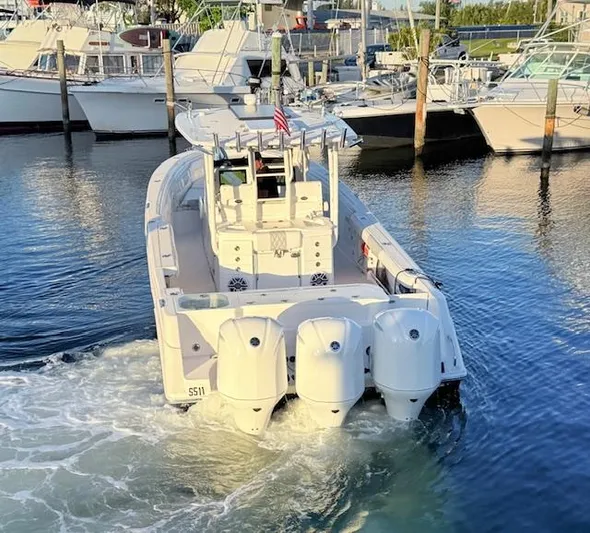  Yacht Photos Pics 2014 Everglades 355 Center Console boat with triple engines in a marina.
