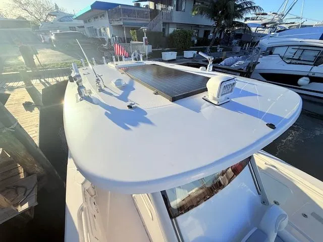  Yacht Photos Pics 2014 Everglades 355 Center Console boat docked, featuring a sleek white design and modern equipment.