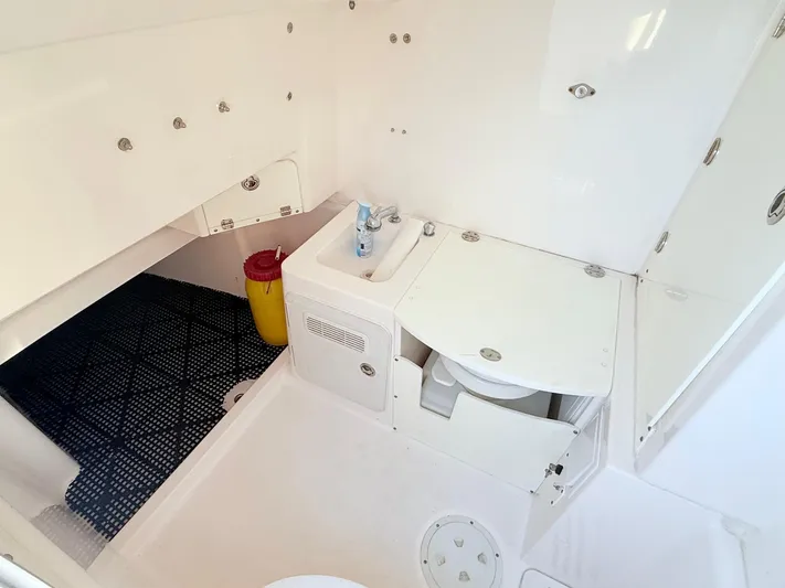  Yacht Photos Pics 2014 Everglades 355 Center Console boat interior with compact bathroom amenities.