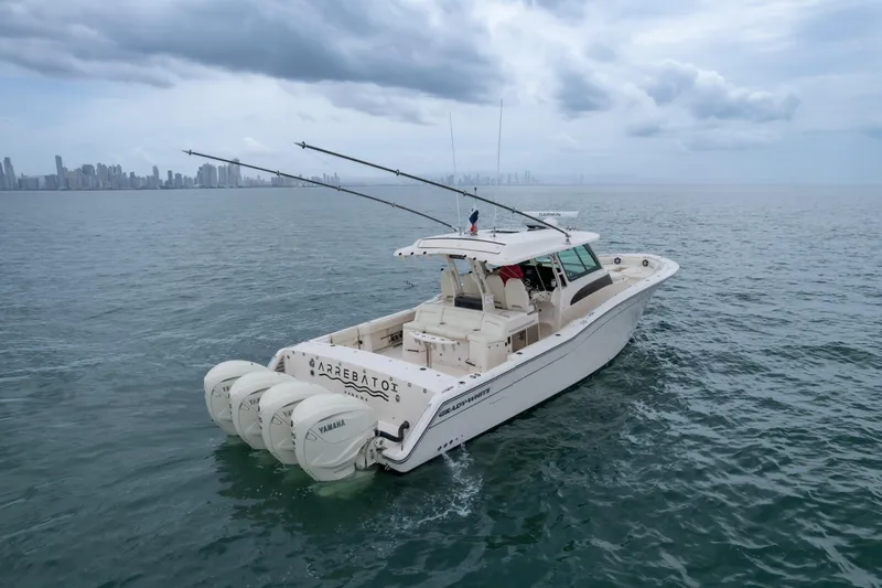  Yacht Photos Pics 2020 Grady-White Canyon 456 boat on open water with city skyline in background.