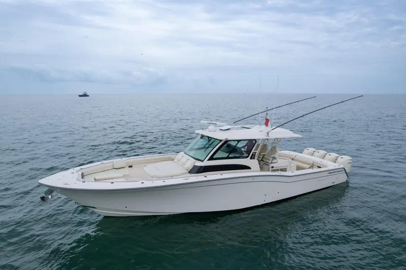  Yacht Photos Pics 2020 Grady-White Canyon 456 boat on calm ocean waters under cloudy sky.