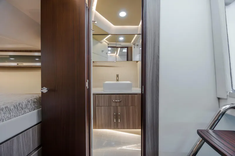 Yacht Photos Pics Interior of 2022 Regal 36 Grande Coupe bathroom with modern sink and wood accents.