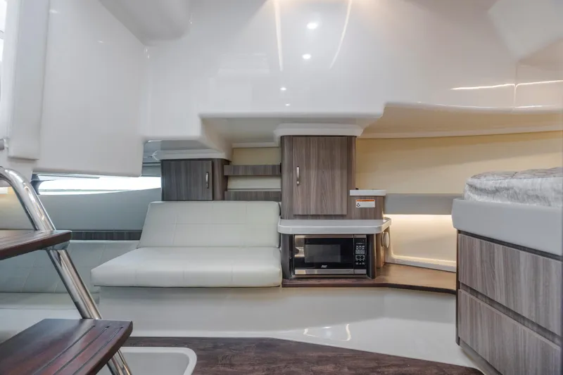  Yacht Photos Pics Interior of 2022 Regal 36 Grande Coupe with sofa, microwave, and modern cabinetry.